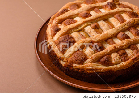 Sweet American pie with apples, pears, and cinnamon, a homemade dessert. Apple American pie Sweet American pie with apples, pears, and cinnamon, a homemade dessert. Apple American pie 133503879