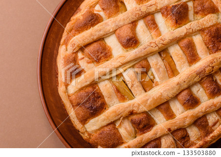 Sweet American pie with apples, pears, and cinnamon, a homemade dessert. Apple American pie Sweet American pie with apples, pears, and cinnamon, a homemade dessert. Apple American pie 133503880