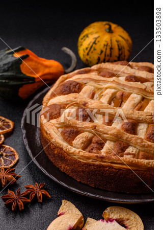 Sweet American pie with apples, pears, and cinnamon, a homemade dessert. Apple American pie Sweet American pie with apples, pears, and cinnamon, a homemade dessert. Apple American pie 133503898