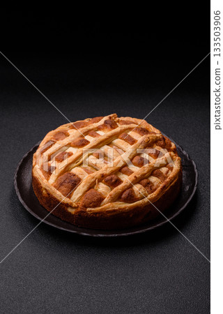 Sweet American pie with apples, pears, and cinnamon, a homemade dessert. Apple American pie Sweet American pie with apples, pears, and cinnamon, a homemade dessert. Apple American pie 133503906
