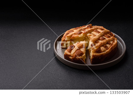 Sweet American pie with apples, pears, and cinnamon, a homemade dessert. Apple American pie Sweet American pie with apples, pears, and cinnamon, a homemade dessert. Apple American pie 133503907