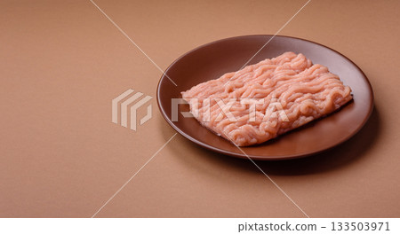 Raw minced chicken for a burger or as an ingredient in a meat dish. Raw ground chicken 133503971
