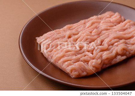 Raw minced chicken for a burger or as an ingredient in a meat dish. Raw ground chicken 133504047