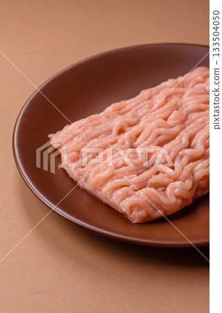 Raw minced chicken for a burger or as an ingredient in a meat dish. Raw ground chicken Raw minced chicken for a burger or as an ingredient in a meat dish. Raw ground chicken 133504050