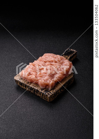 Raw minced chicken for a burger or as an ingredient in a meat dish. Raw ground chicken 133504062