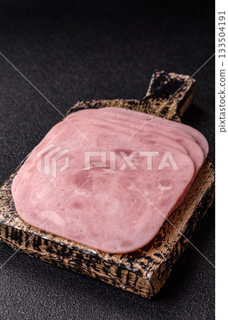 Meat, square ham sliced, organic food, protein for snacks. Sliced ham as a background Meat, square ham sliced, organic food, protein for snacks. Sliced ham as a background 133504191