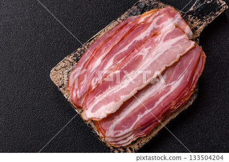 Meat, raw pork bacon sliced, organic food, protein for snacks. Raw bacon as a background Meat, raw pork bacon sliced, organic food, protein for snacks. Raw bacon as a background 133504204