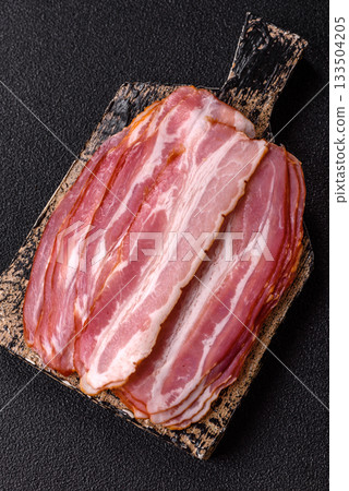 Meat, raw pork bacon sliced, organic food, protein for snacks. Raw bacon as a background Meat, raw pork bacon sliced, organic food, protein for snacks. Raw bacon as a background 133504205