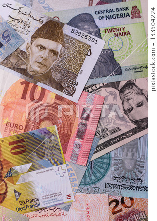 Paper money, banknotes of different countries as a business background. Paper money and cash Paper money, banknotes of different countries as a business background. Paper money and cash 133504224