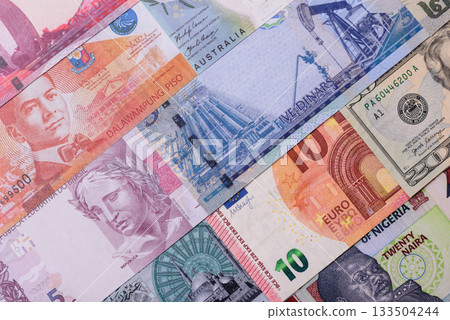 Paper money, banknotes of different countries as a business background. Paper money and cash Paper money, banknotes of different countries as a business background. Paper money and cash 133504244