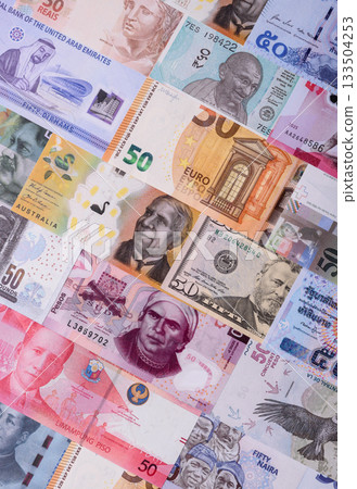 Paper money, banknotes of different countries as a business background. Paper money and cash 133504253