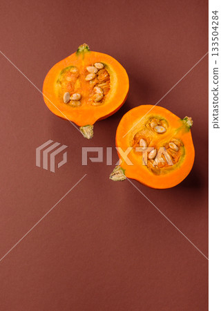 Half a raw pumpkin, a ripe orange colored butternut squash. Raw pumpkin Half a raw pumpkin, a ripe orange colored butternut squash. Raw pumpkin 133504284