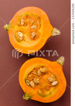 Half a raw pumpkin, a ripe orange colored butternut squash. Raw pumpkin Half a raw pumpkin, a ripe orange colored butternut squash. Raw pumpkin 133504290