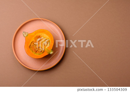 Half a raw pumpkin, a ripe orange colored butternut squash. Raw pumpkin Half a raw pumpkin, a ripe orange colored butternut squash. Raw pumpkin 133504309
