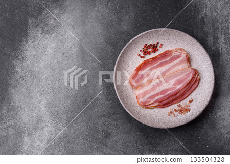 Meat, raw pork bacon sliced, organic food, protein for snacks. Raw bacon as a background Meat, raw pork bacon sliced, organic food, protein for snacks. Raw bacon as a background 133504328