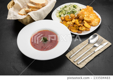 Ukrainian lunch set: borscht, fried potatoes, schnitzel and fresh cabbage salad 133504483