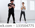 Young woman receiving training from a personal trainer Young woman receiving training from a personal trainer 133504775
