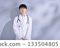 Portrait of a young male doctor in a white coat Portrait of a young male doctor in a white coat 133504805