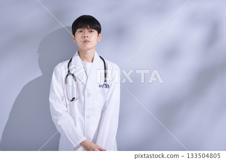 Portrait of a young male doctor in a white coat Portrait of a young male doctor in a white coat 133504805