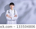 Portrait of a young male doctor in a white coat Portrait of a young male doctor in a white coat 133504806