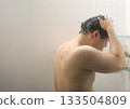 A man in his twenties taking a shower A man in his twenties taking a shower 133504809