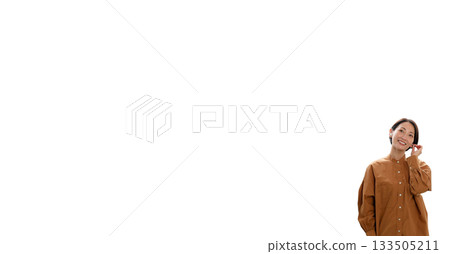 Woman (small) listening to music or the radio 133505211