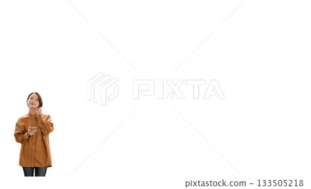 Woman (small) listening to music or the radio 133505218