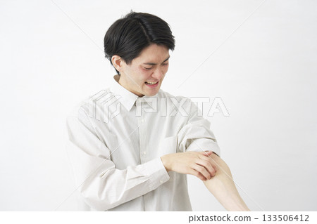 Man scratching his arm white background Man scratching his arm white background 133506412