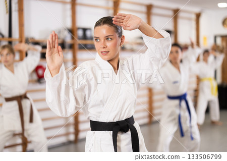 Young women during group karate training 133506799