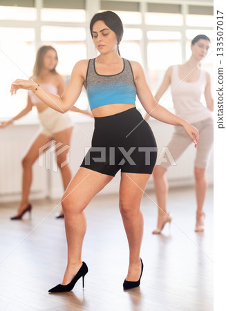 During lesson, Armenian girl learn to move and perform dance in heels with women companions 133507017