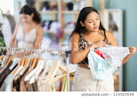 Young woman chooses panties in clothing store 133507039