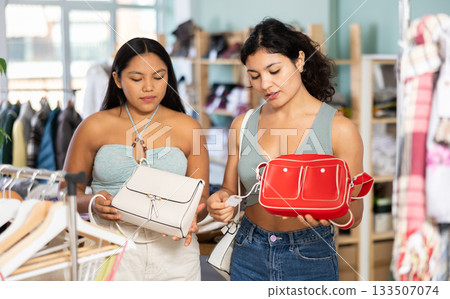 Two Latins choose bags in the store 133507074