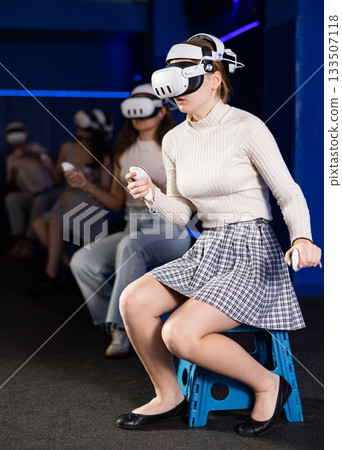 Excited young girl playing virtual reality game Excited young girl playing virtual reality game 133507118