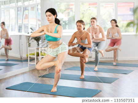 Fitness, sport and healthy lifestyle concept: woman doing yoga yoga pose - vrikshasana pose Fitness, sport and healthy lifestyle concept: woman doing yoga yoga pose - vrikshasana pose 133507351
