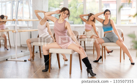 Sitting on chair, girl train to perform lap dance, interacting with imaginary partner 133507355