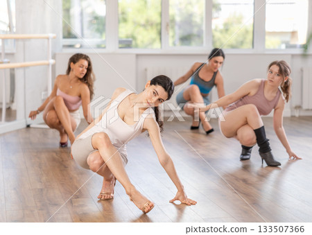 Slim brunette in heels practicing jazz-funk dance in studio Slim brunette in heels practicing jazz-funk dance in studio 133507366