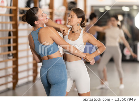 Young women in self-defense training Young women in self-defense training 133507949