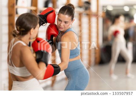 Young women in gym boxing training 133507957