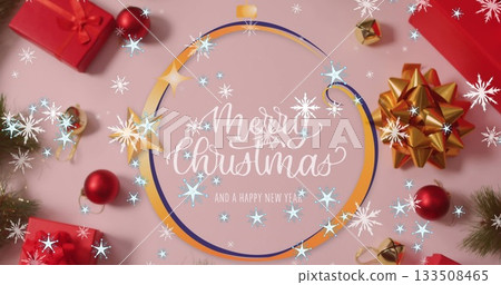 Showcasing frame with holiday text on pink tabletop, with red gift boxes, baubles, gold bow Showcasing frame with holiday text on pink tabletop, with red gift boxes, baubles, gold bow 133508465