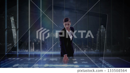 Businesswoman in suit operating holographic table in office displaying digital charts and icons Businesswoman in suit operating holographic table in office displaying digital charts and icons 133508564