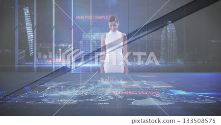 Engineer in white dress using holographic map at tech hub, analysis complete text 133508575