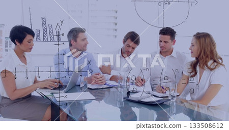 Collaborating business professionals analyzing charts on glass table in meeting room, with laptops 133508612