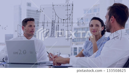 Collaborating trio analyzing charts at modern conference table, with laptop, pen, glass of water 133508625