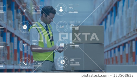 Operating scanner, worker in neon vest scanning pallet boxes at warehouse with digital overlays 133508632