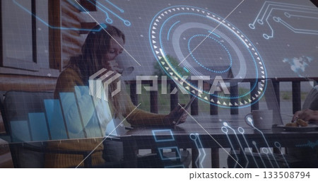 Woman and man collaborating at wooden balcony table on tablet and laptop, with AR graphics Woman and man collaborating at wooden balcony table on tablet and laptop, with AR graphics 133508794