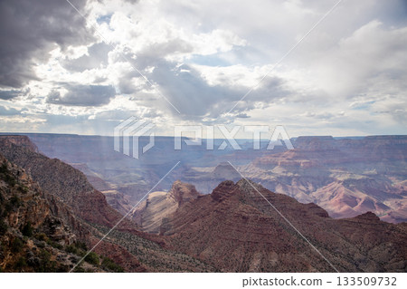 Atmospheric Grand Canyon View with Sunlight Breaking Through Clouds 133509732
