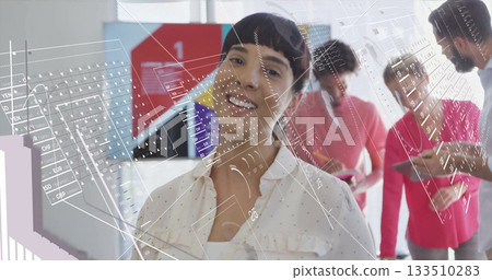 Multicultural woman standing and smiling in open office, with tablets and holographic overlays 133510283