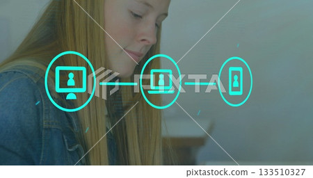 Leaning teenage girl studying network icons at study desk, with turquoise digital icons, copy space Leaning teenage girl studying network icons at study desk, with turquoise digital icons, copy space 133510327