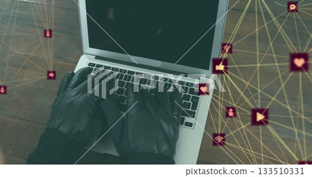Typing black leather-gloved hands pressing laptop keys at office desk, social network icons overlay Typing black leather-gloved hands pressing laptop keys at office desk, social network icons overlay 133510331