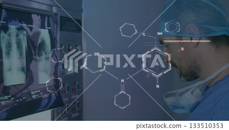 Studying doctor in scrubs reading X-rays in control room, monitor, panel, chem diagrams, copy space Studying doctor in scrubs reading X-rays in control room, monitor, panel, chem diagrams, copy space 133510353